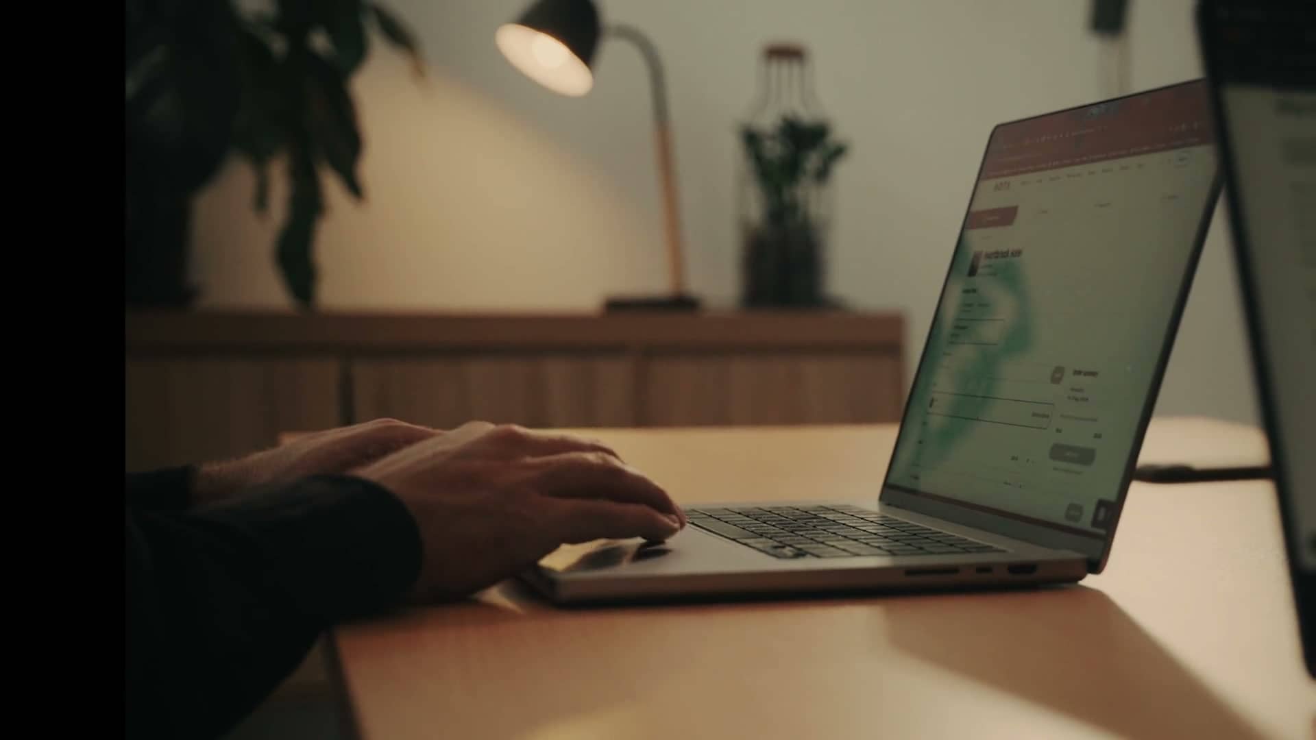 Hands typing on an open laptop during a strategy session